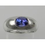 An 18 carat white gold and tanzanite ring, set oval cut AA coloured tanzanite.