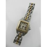 Cartier. A white and yellow metal ladies wristwatch, quartz movement.