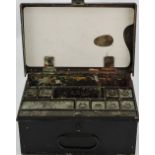 An early 20th Century black tin artists box with compartmented interior incorporating a palette. W.