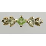 A five-stone stone ring, the claw set stones possibly peridot in a yellow metal band stamped 375,