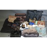 A collection of designer handbags in leather and canvas together with luggage, (qty).