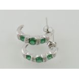 A pair of diamond and emerald hoop earrings, set in white metal stamped 14K, 3.