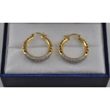 A pair of 18ct gold diamond pave set hoop earrings, total 1ct.