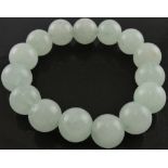 A jade bracelet, of light uniform beads.