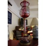 A bohemian style red and clear glass tablelamp and shade on fluted pillar and gilt metal mounted