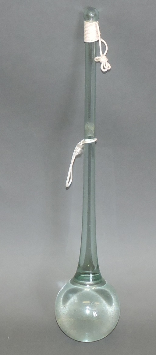 A vintage clear fluid filled sealed glass apparatus tube possibly hydrometer.
