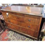 A 1920s flame mahogany three drawer chest of drawers with gallery surround,