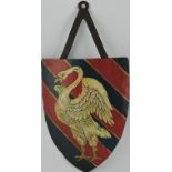 An early 20th Century painted metal heraldic shield decorated with a swan rousant on red and blue