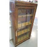 An oak lead glazed display cabinet with single door and four shelves,