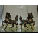 A pair of ornately cast Chinese bronze Shi-Fu lion dogs.
