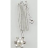 A pearl pendant with diamond accents, in a 9ct white gold mount, with a 9ct white gold chain,