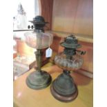 An early 20th Century brass oil lamp base with clear glass reservoir, H.