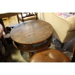 An Indian circular hardwood low occasional table with metal lattice frieze.