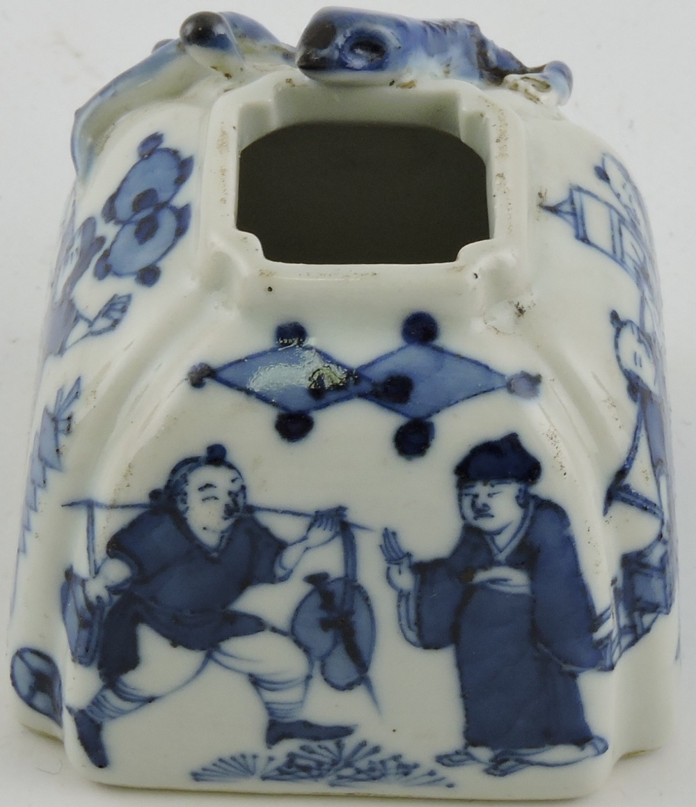 A blue and white water pot, of square form decorated with figures and applied with a lizard,