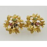 A pair of emerald, ruby and sapphire ear clips, in a yellow metal floral settings and stamped 18k,