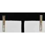 A pair of 18ct white gold rectangular stud earrings each channel set with 8 baguette diamonds