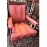 A late Victorian mahogany armchair upholstered in strpied fabric,