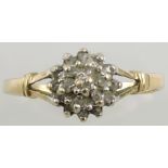 A diamond cluster ring, the stepped claw setting in a yellow metal band stamped 375, 1.5g.