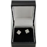 A pair of princess cut diamond ear studs, with 18ct white gold surrounds, each approx. 0.