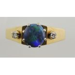 A black opal and diamond set dress ring, on a yellow metal band stamped 750, 6.5g.