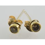 A pair of diamond ear studs, collet set in yellow metal, 0.5g.