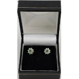 A pair of emerald and diamond cluster ear studs, approx. 30pts of emeralds and 16 diamonds.