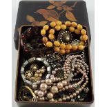 An early 20th century Japanese lacquer box with assorted costume jewellery,