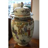 A famille rose porcelain jar and cover decorated with a band of figures, H. 40cm.