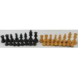 A Staunton chess set, turned boxwood with one side natural with the other eboinsed,