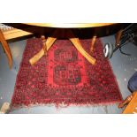 A Bokhara red ground rug woven four central octagonal medallions within a wide border,