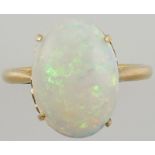 An opal dress ring, claw set in a yellow metal band, 3.5g.