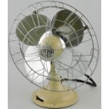 A mid 20th century cream painted oscillating desk fan by Limit,