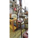 A vintage style plated telescope on adjustable wood tripod.