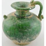 A green glazed jug, possibly for wine, with an everted lip,