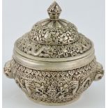 A white metal incense burner, cast with dragons chasing a flaming pearl, with dragon mask handles,