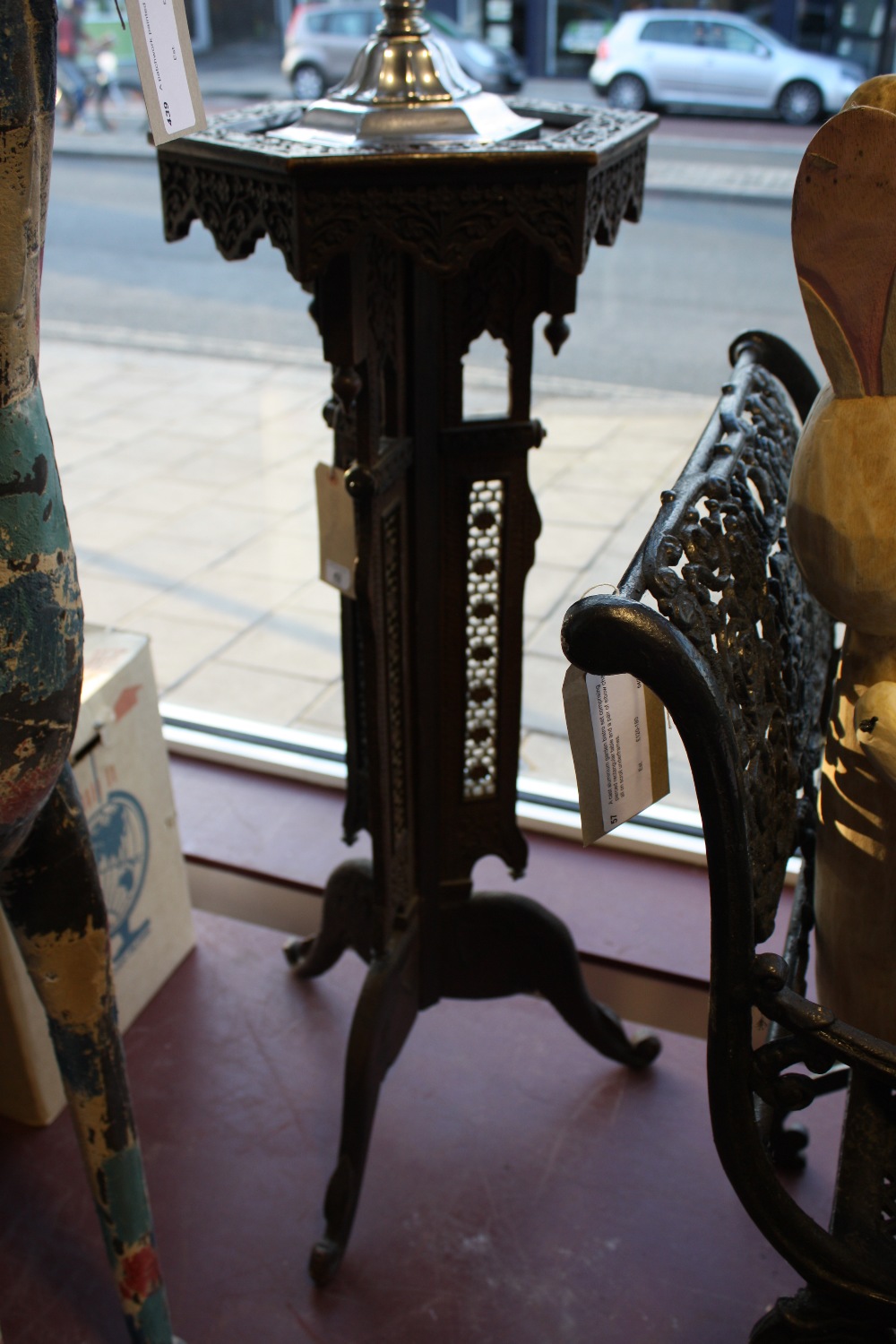 A damascan carved hardwood jardiniere stand with hexagonal top on triangular column and tripod, H.