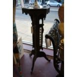 A damascan carved hardwood jardiniere stand with hexagonal top on triangular column and tripod, H.