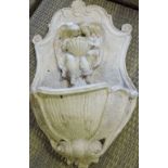 A Victorian style plaster garden wall pocket cast with angels.