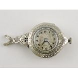 An early 20th Century 14ct white gold diamond set ladies pendant fob watch with engraved foliate