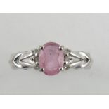 A pink tourmaline and diamond set ring, on a white metal  band.