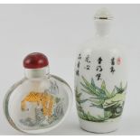 A Chinese interior decorated glass scent bottle together with a ceramic bottle with bamboo shoot