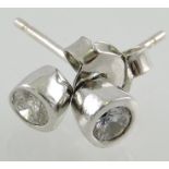 A pair of diamond stud earrings, set in white metal, 1g.