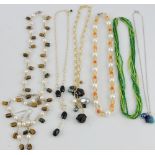 A collection of six assorted hardstone necklaces, one with matching bracelet and earrings.