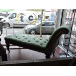 A mid Victorian mahogany daybed upholstered in buttoned green fabric on fluted tapered legs, L.