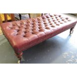 A Victorian rectangular footstool with deep buttoned burgundy leather upholstery over a stud frieze