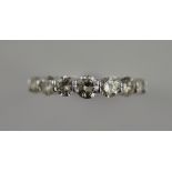 An 18ct white gold seven stone diamond ring, total 1.