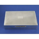 A silver rectangular cigarette box, Birmingham 1956, with engine-turned lid, W. 15cm.