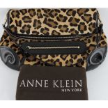 A faux leopard skin handbag by Anne Klein, with black patent leather fittings,