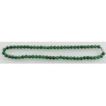 A jade necklace, of uniform beads, L. 44cm.