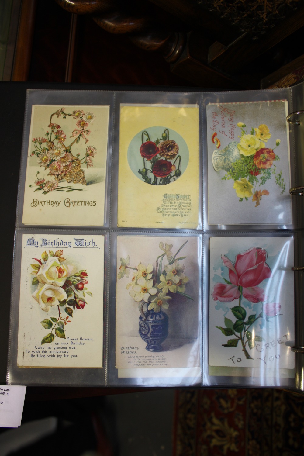 An album of approx 100 coloured and monochrome postcards early 20th Century and later,